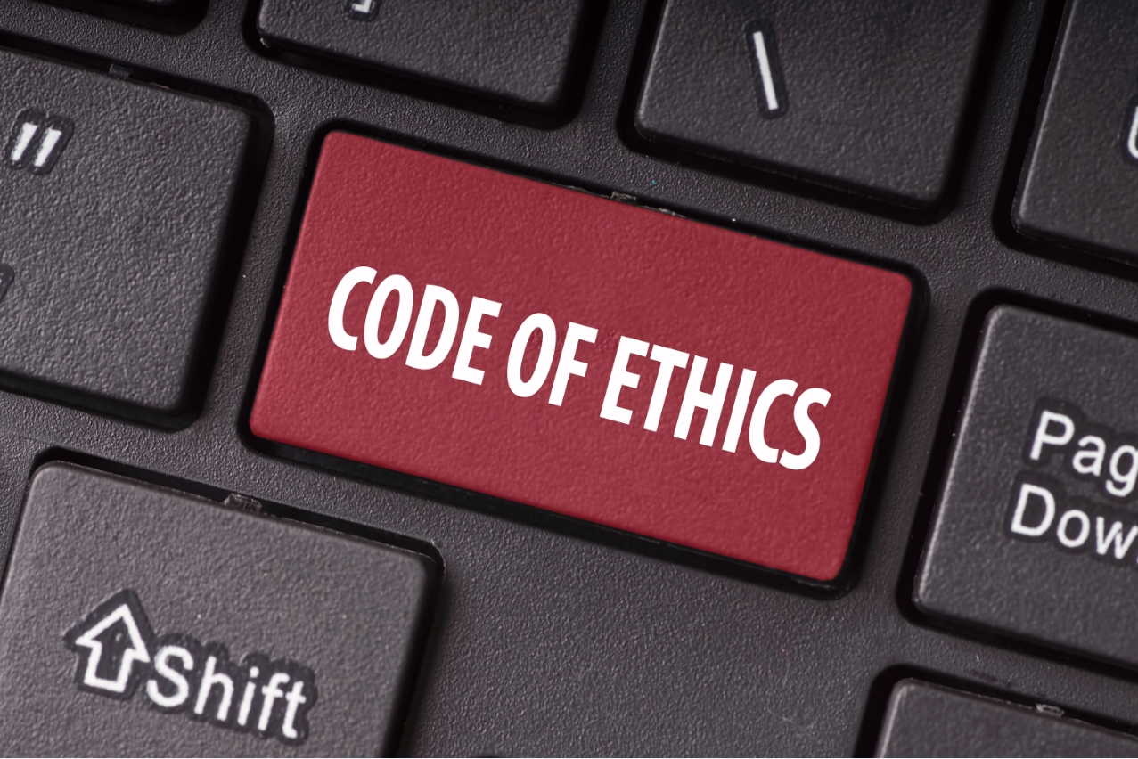 A keyboard key with words (Code of Ethics)